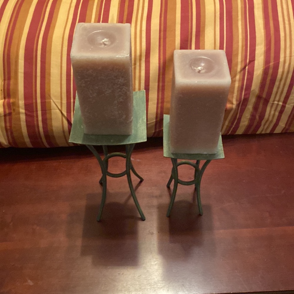 2 green metal candle holders. 2 sizes with 2 rectangular candles each 6 inches